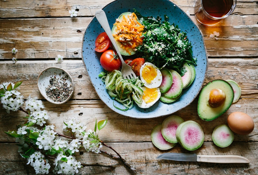 A balanced meal of eggs, avocado, tomatoes and leafy greens on a blue plate